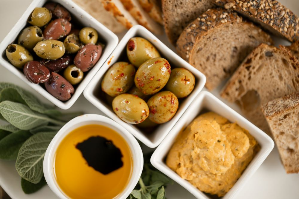 fresh olives and olive oil dip with bread for tasting experience
