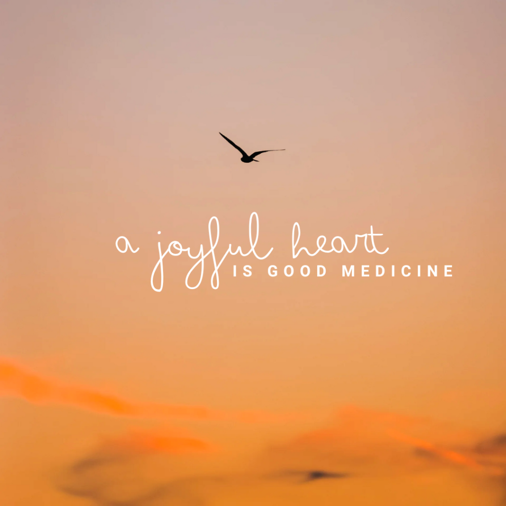 uplifting scripture verse graphic with proverbs 1722 a joyful heart is good medicine displayed on a serene sky