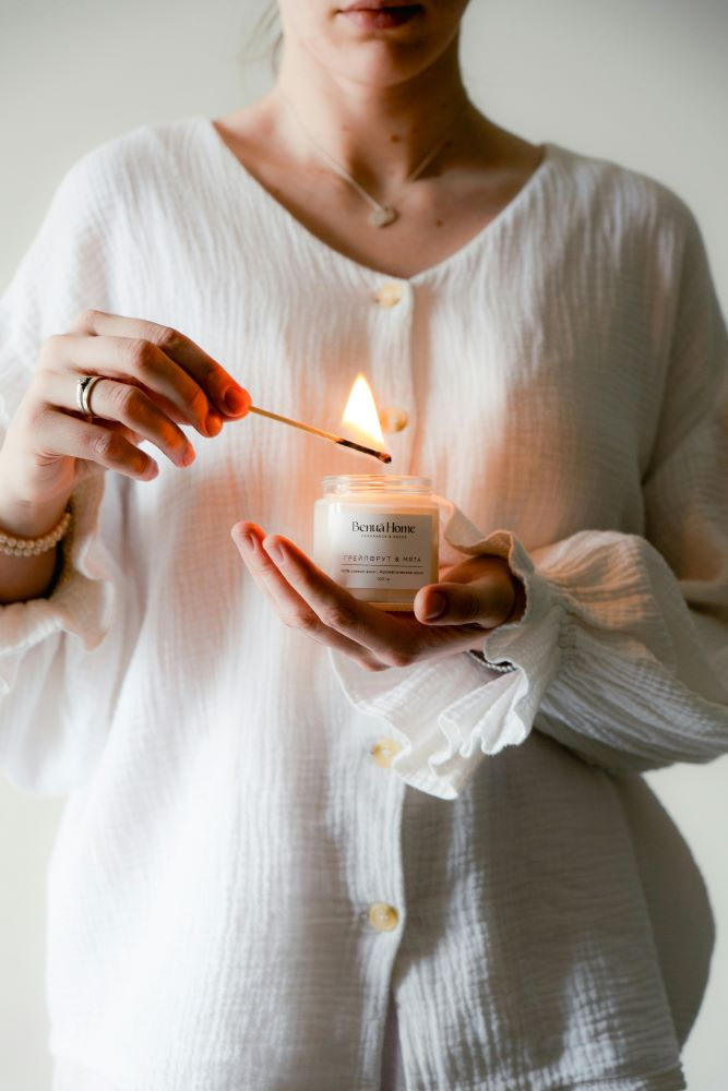 woman lighting candle reset your spirit